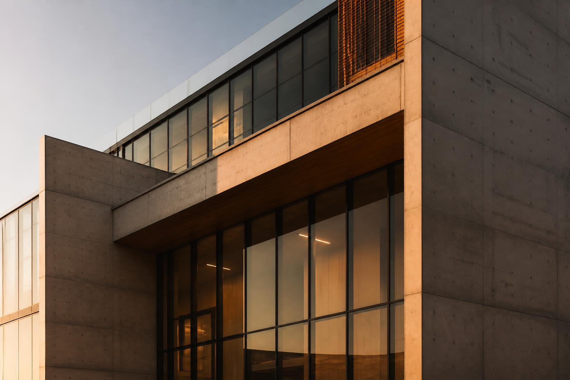 Modern concrete and glass building facade at golden hour